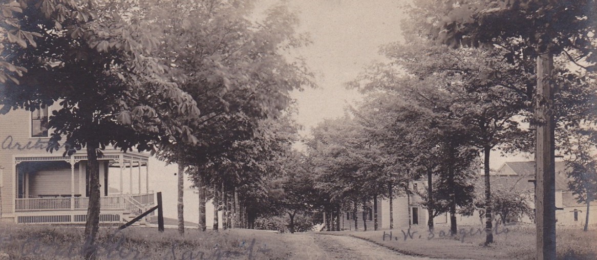 The buildings to the right in this early view looking down Maple Ave. are the home built by Joseph Eaton.