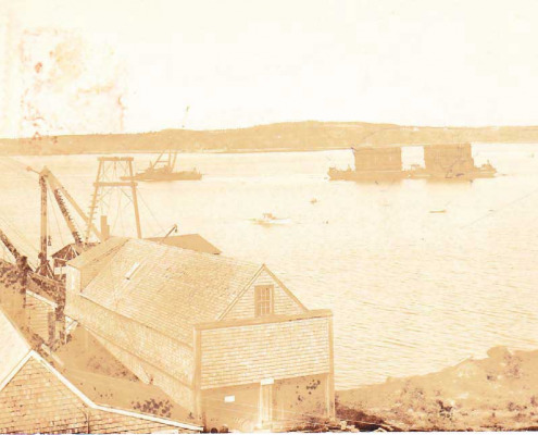 Some of the equipment used in building the Deer Isle Bridge. The old clam wharf and canning factory were used during bridge construction
