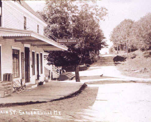 Brook Haven, the fruit and ice cream store. The door at this end opened into the ice cream parlor where one sat at little round metal tables to be served dishes of ice cream. Later the door went into the post office and the store was Rollie Gray’s, now Butch Gray’s home and workshop.