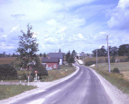 Looking west along the same road in the 1960s.