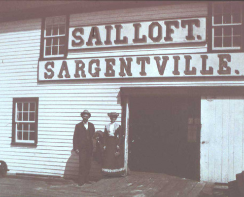 Waiting for the boat. Harding’s sail loft was once in a building between the steamer wharf and Pleasant Cove and later was in the main steamer wharf building.