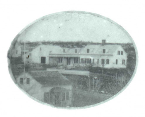 Three houses in the heart of Sargentville , all in a row, were built from the same plans by William Haskell Sargent. One is the Sargent house built in 1843 for Captain Jasper Sargent. This is a very early view of the home showing bare rocky pastures and the W. G. Sargent store across the road.