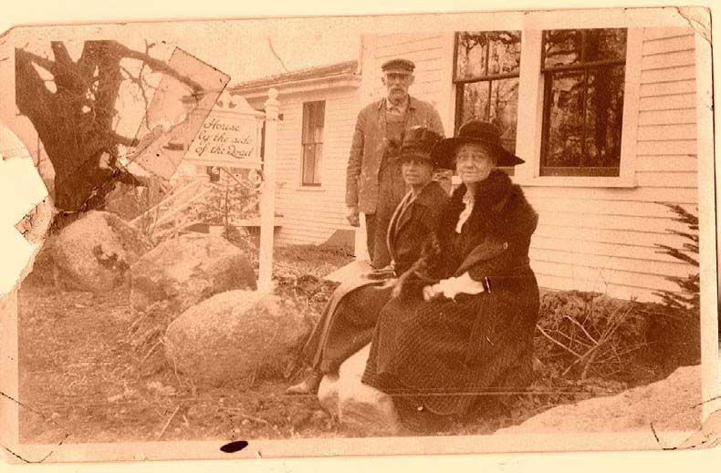 Sally summered in Sargentville where she bought a house at the corner of Reach and Caterpillar Hill Road which she called The House by the Side of the Road. In this photo Sally is seated with a lady who may have been her cook.  Franklin Billings stands behind them.