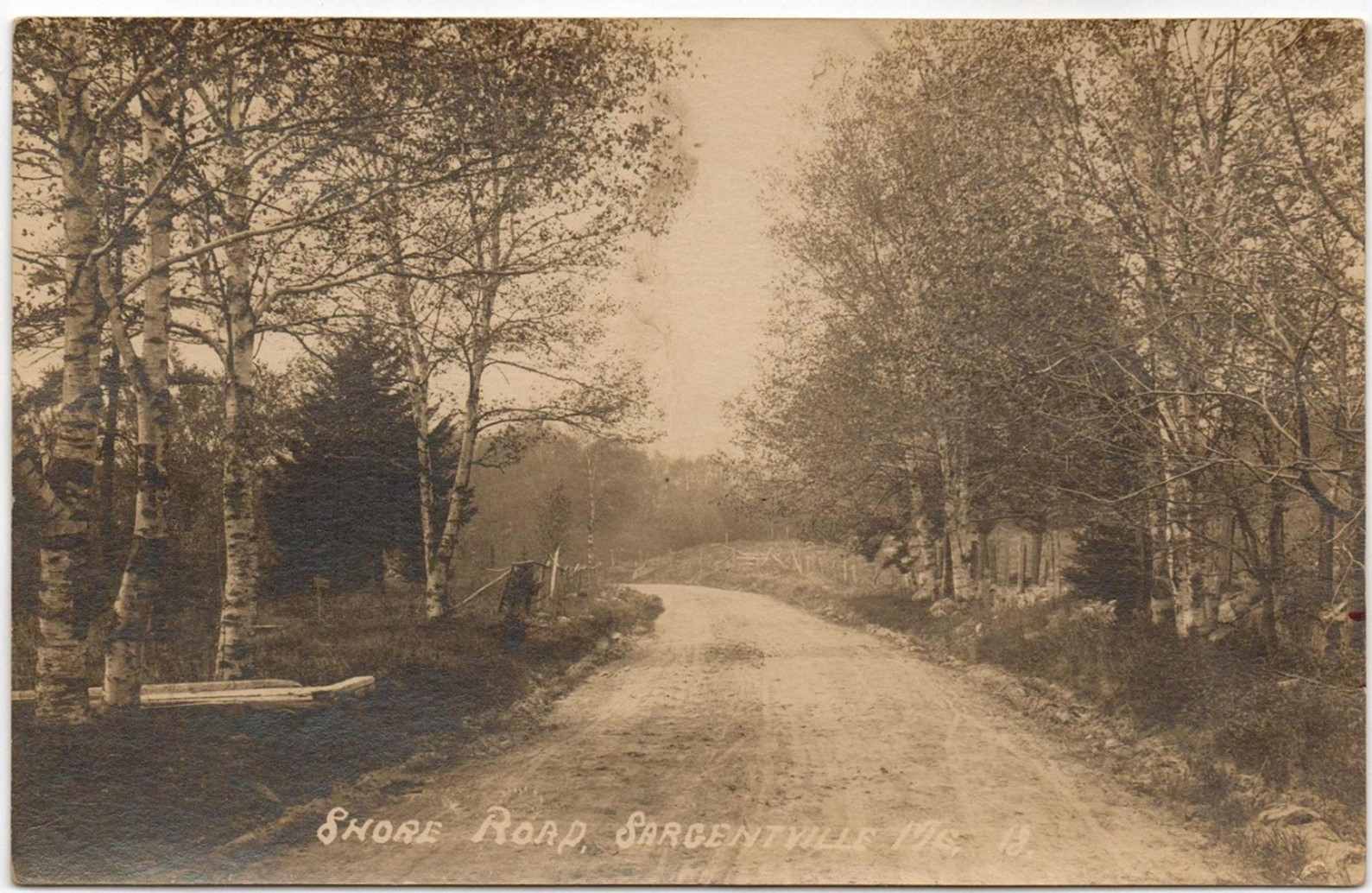 This is a photo of the beginning of the Shore Road in the late 1800s. Wyer G. Sargent’s property was on the right and the grist mill was on the left.