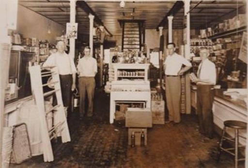 Ernest Grindle is on the far left in this 1929 photo taken inside Wyer Sargent’s Store.  Ernest and his wife, Hattie Orcutt Grindal, are buried in Forest Home cemetery.
