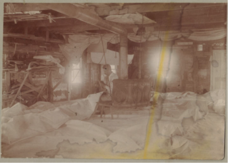 Another view of the inside of the Harding sail loft.  Note the stove hanging from the ceiling so as to accommodate the sails stretched below it.