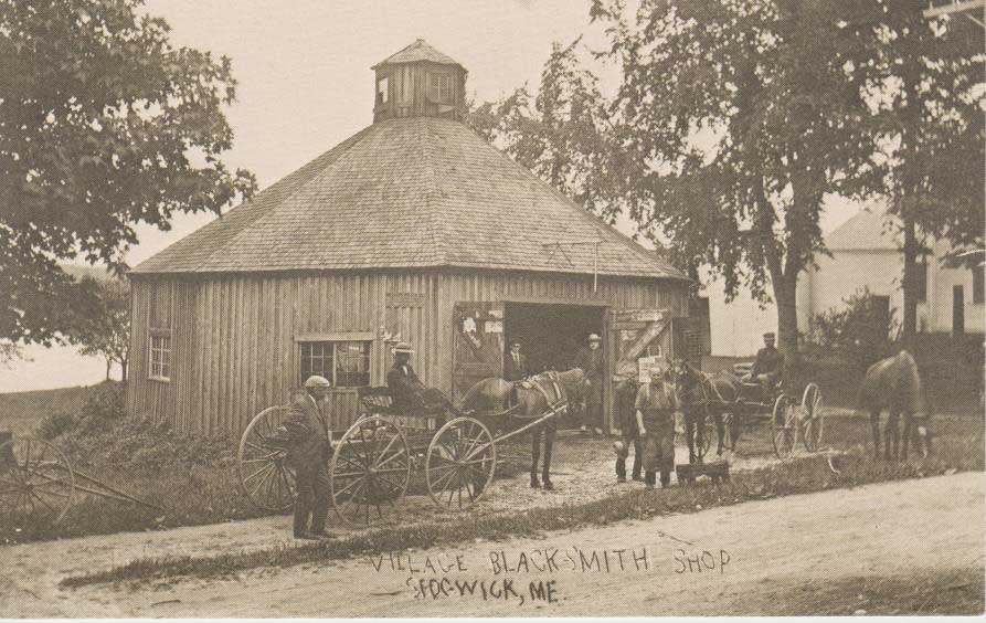 This is one of several blacksmith shops in Sedgwick in the years before autos replaced horses. It was located between Mrs. Cousins and Mrs. Choate near the former Sedgwick Store and is thought to have belonged to Austin H. and Lucy Dority whose children were Laura, Roy and Myra. By 1910 Austin was retired.