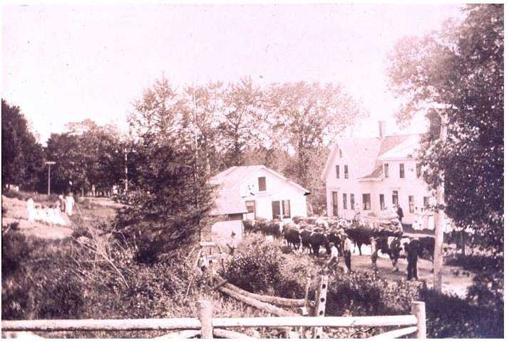 In this photo the building is now moving past Parker Billings home on the right with the front yard of Rock Hill, on the left.  Also, on the left, you can see the well house that stood next to the road, in front of Rock Hill. It is said that Parker Billings got his water from that well. Parker’s house burned to the ground in 1947.